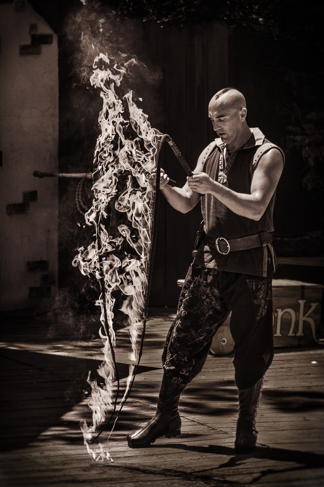 Prayers to the fiery serpents. Aaron Bonk with his flaming whips before the Birds of Prey show.